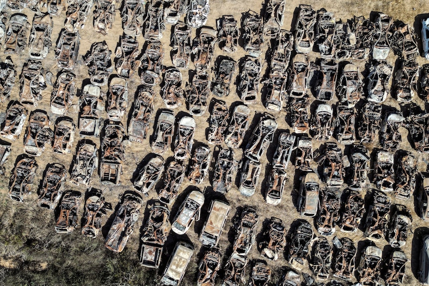 A view from above showing rows of cars that have been destroyed.
