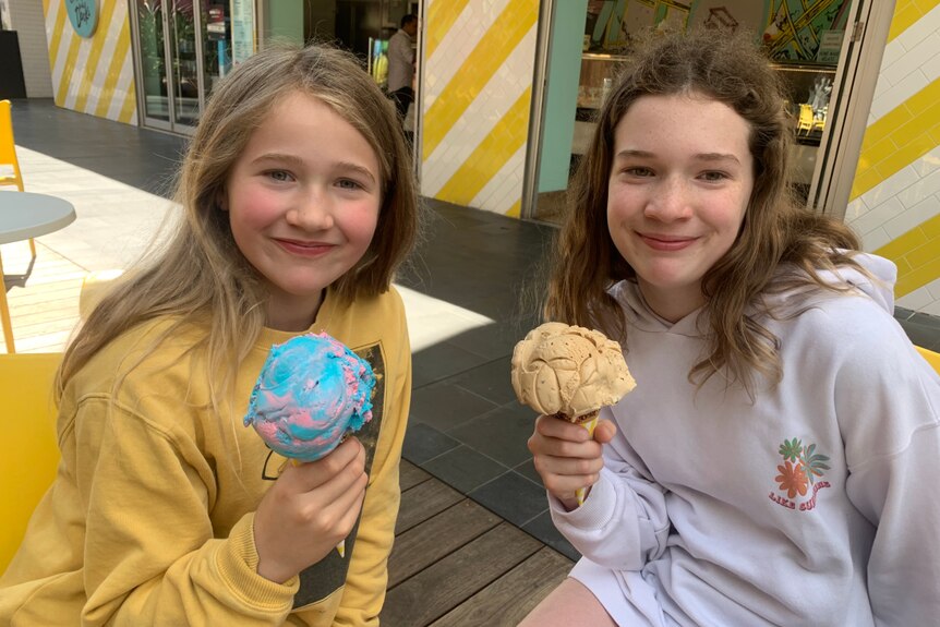 Shona's daughters hold an ice cream cone each