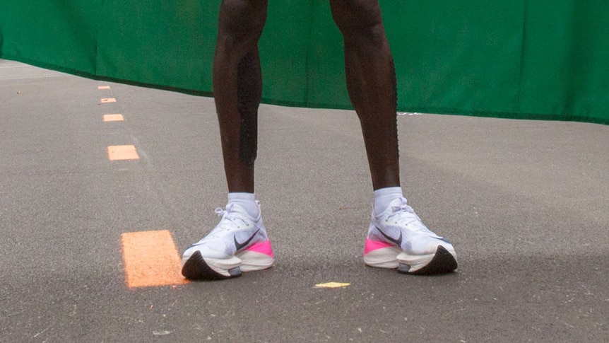 The legs of marathon champion Eliud Kipshoge wearing proto-type running shoes that have cause much debate