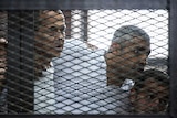 Peter Greste, Mohamed Fahmy and Baher Mohamed listen to their verdict.