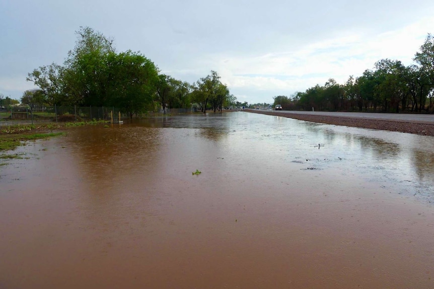Flooding on the side of a road after an intense storm in a WA town.