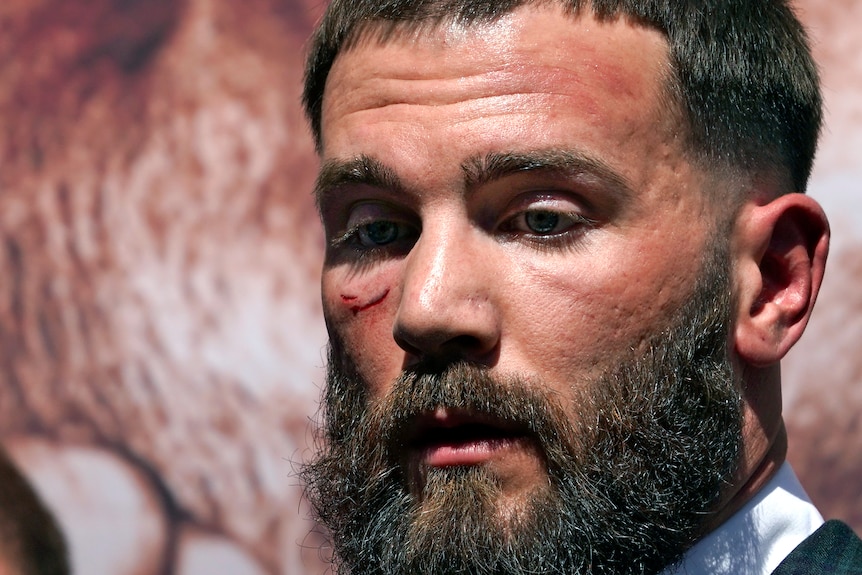 Head shot of a man with a cut under his eye 