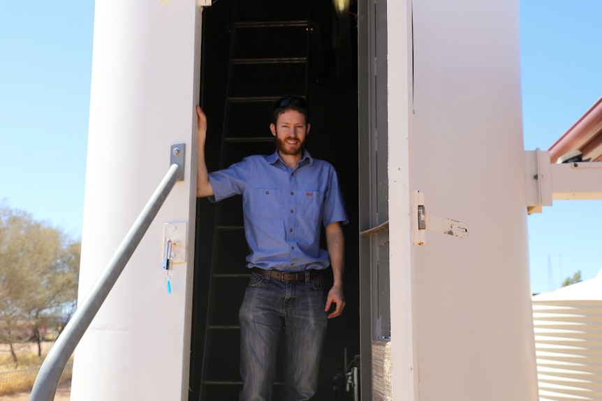 Radar expert and technician Daniel Knowles stands in the door to the radar at Giles Weather Station.