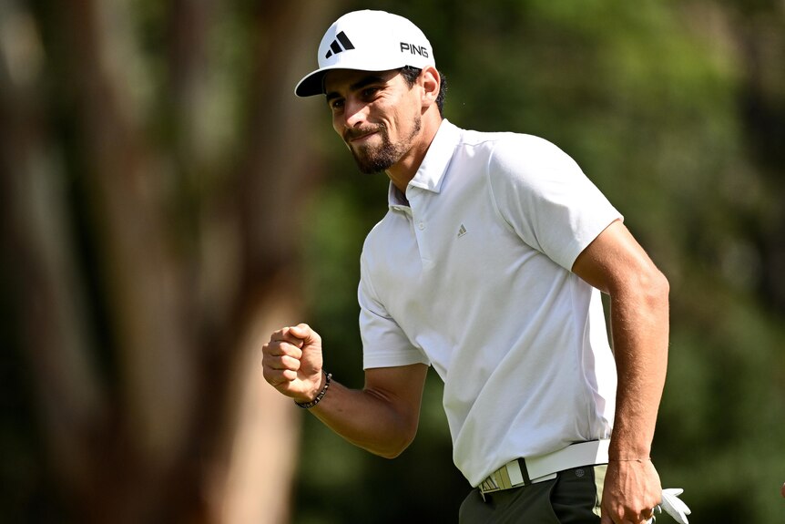 Joaquin Niemann celebrates sinking a putt by pumping his right fist during the final round of the men's Australian Open.