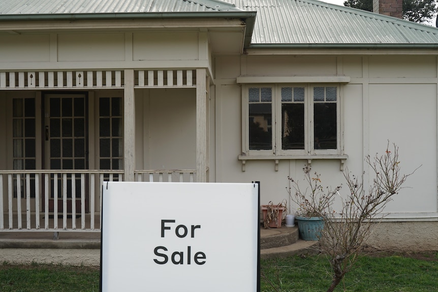 A for sale sign in front of a house