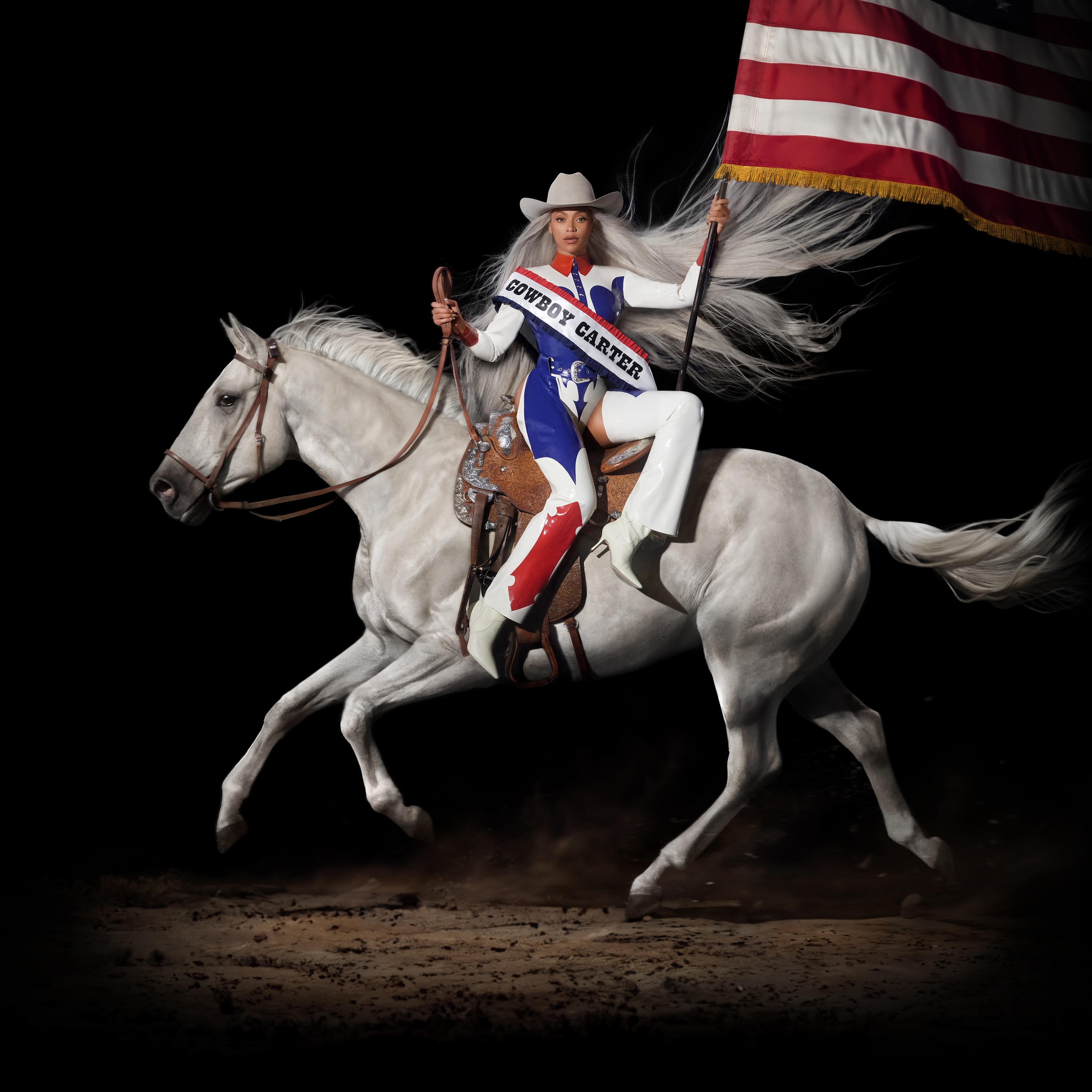Beyoncé rides white horse in red/white/blue rodeo suit, cowboy hat, bearing a red/white flag & sash reading COWBOY CARTER