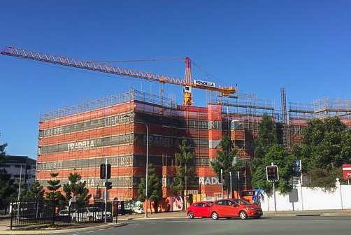 Construction of apartment block with crane