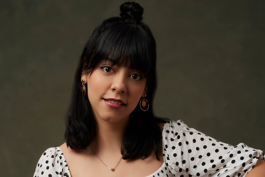 A Mexican woman in a white dress with black spots