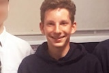 boy smiling in a classroom