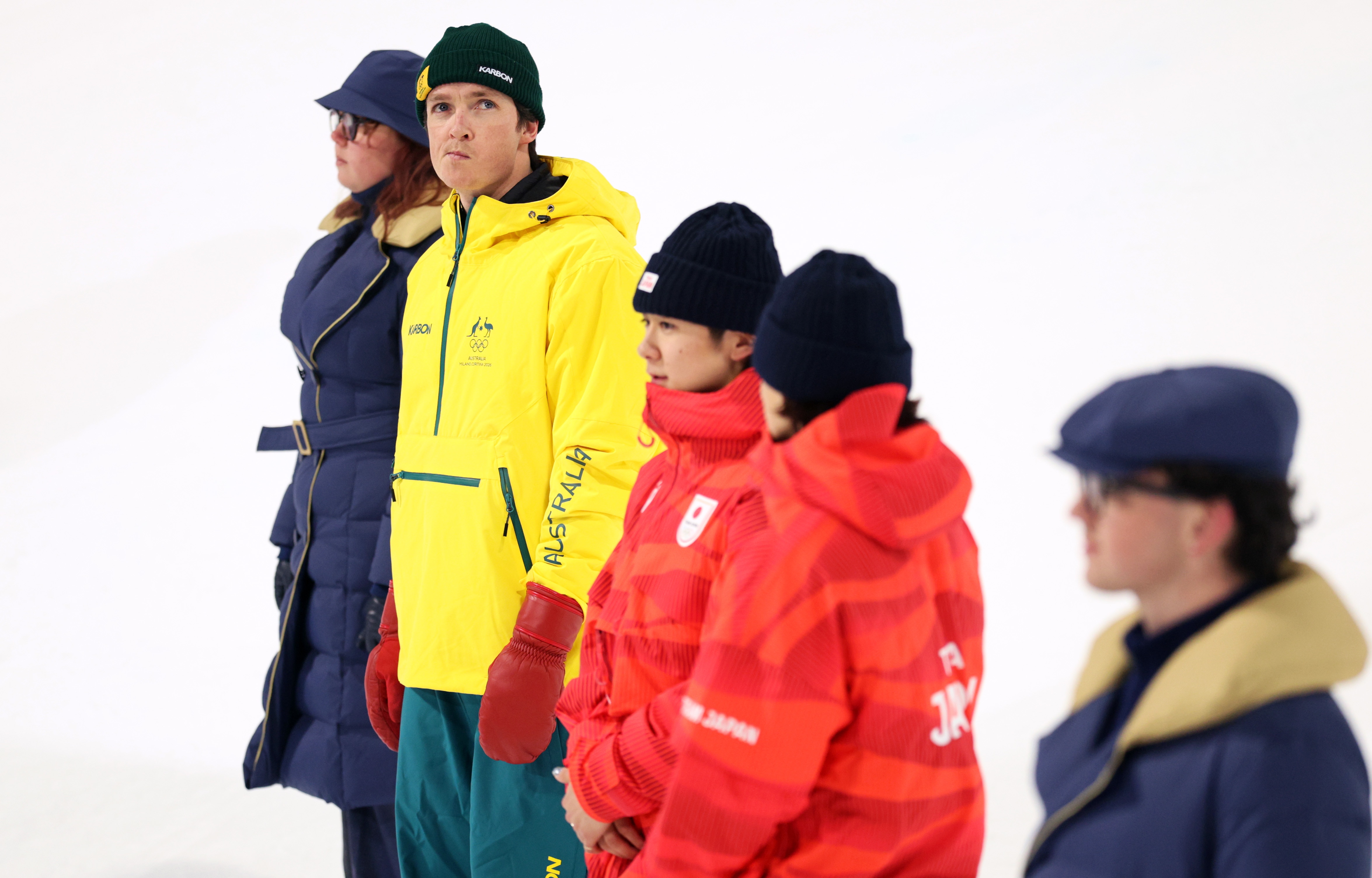A line of people in snow gear.