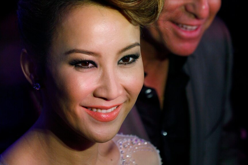 A close up of CoCo Lee dressed up for an event.