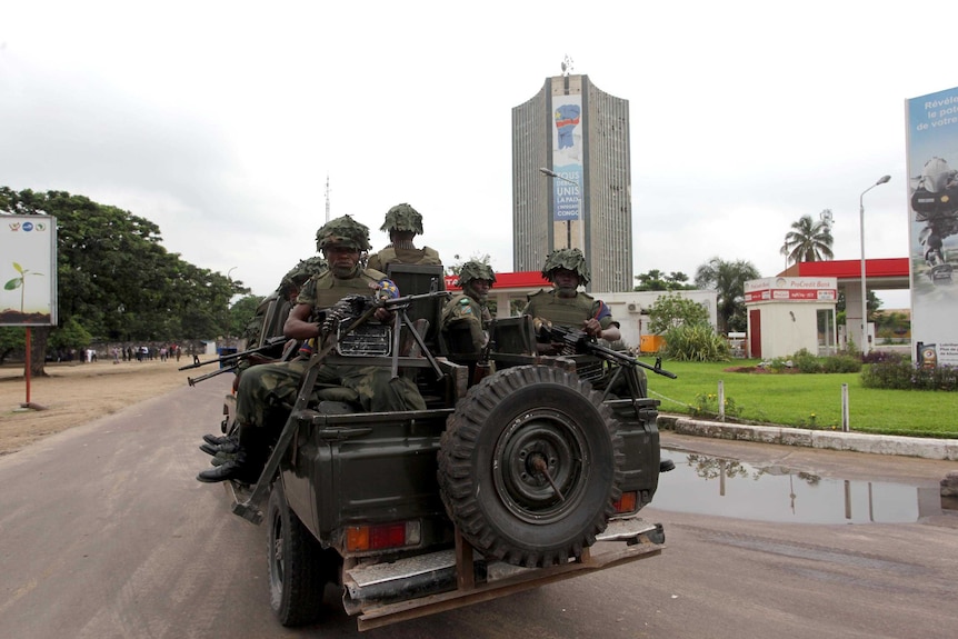 Members of the Democratic Republic of Congo Army patrol in a vehicle