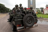 Members of the Democratic Republic of Congo Army patrol in a vehicle