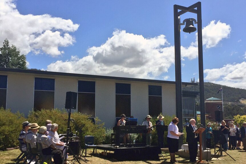 A church bell is dedicated at Snug to bushfire victims