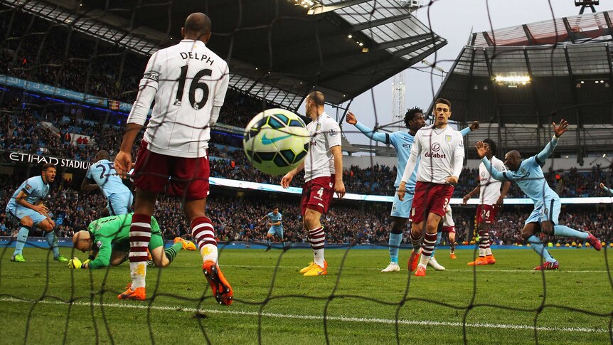 Manchester City's Fernandinho scores his team's third goal past Aston Villa's Brad Guzan.
