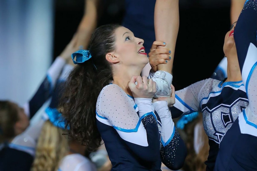 Cheerleader Lan Hopkins performing at the national titles for the Queensland Cheer Elite team.