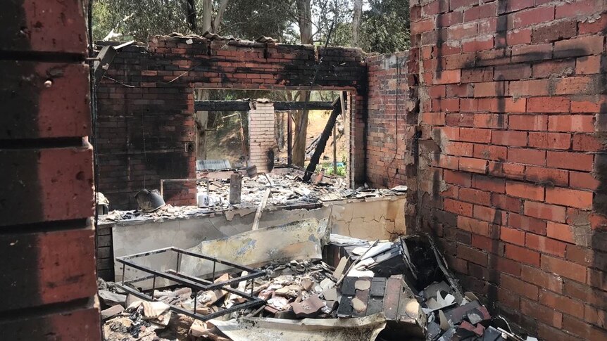 Damaged red brick walls and rubble on the ground