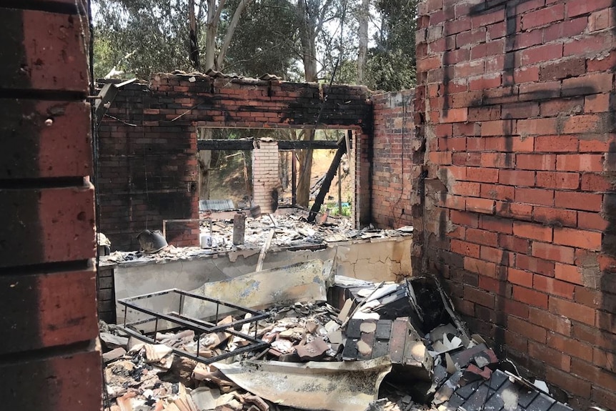 Damaged red brick walls and rubble on the ground