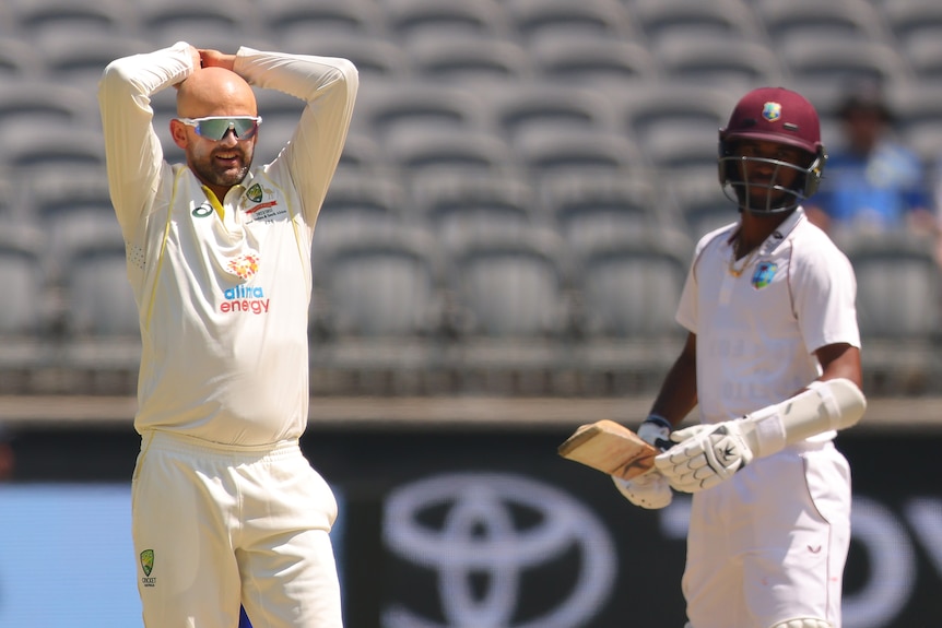 Australia bowler Nathan Lyon puts his hands on his head during a day in the field during a Test against the West Indies.