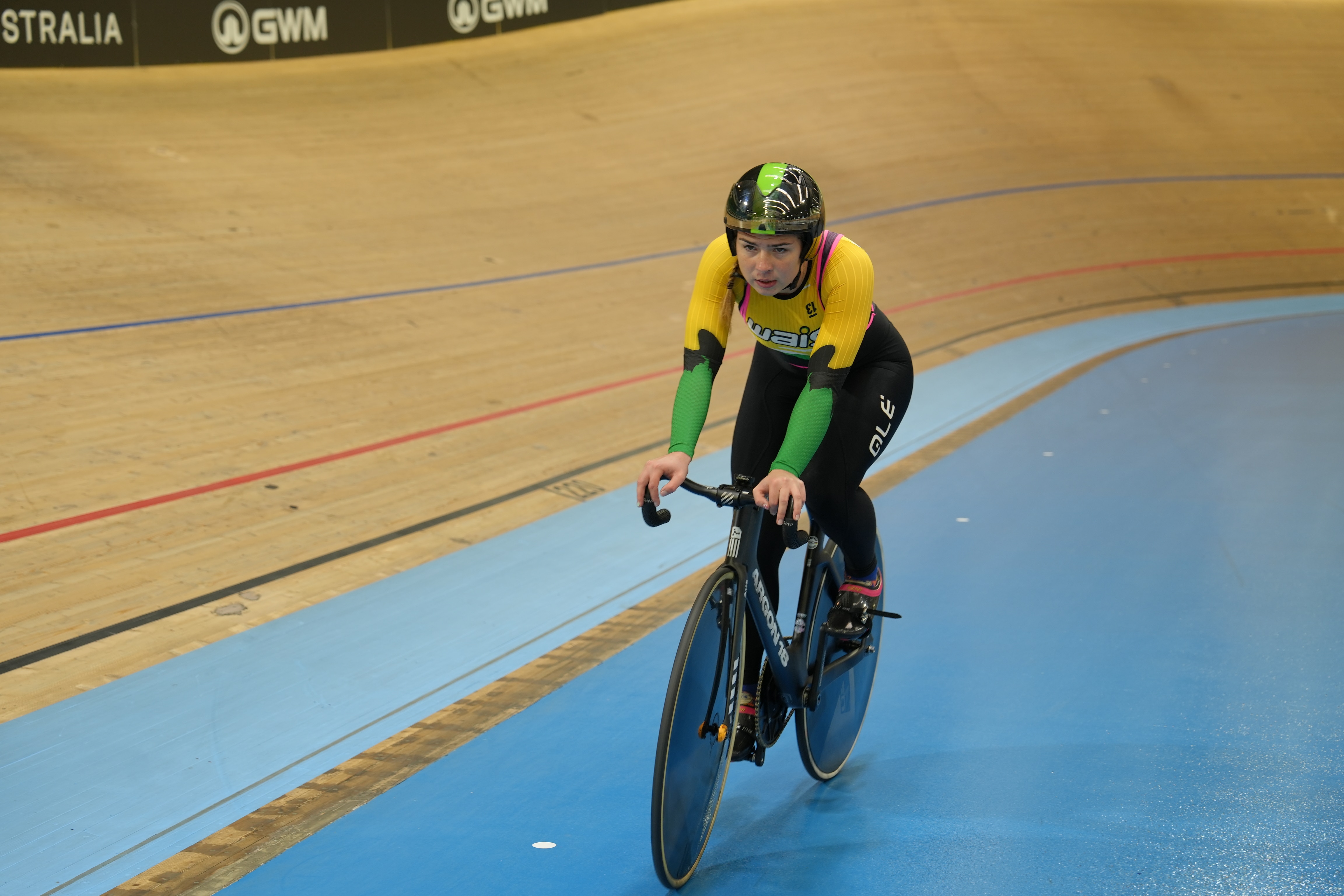 Liliya Tatarinoff rides a bike around a velodrome. 