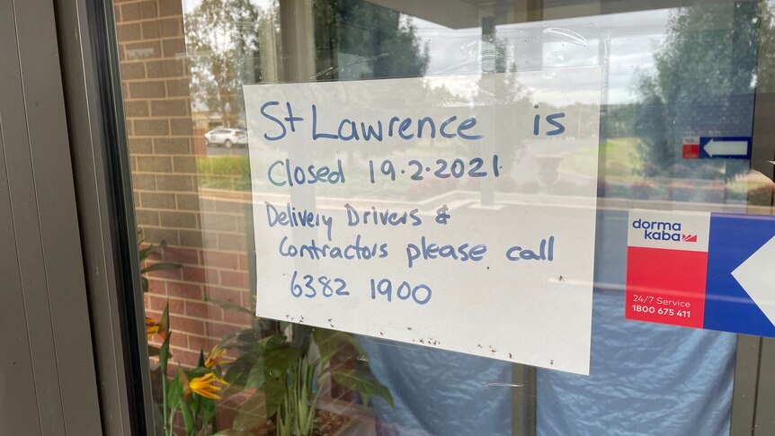 A handwritten sign taped to a glass door says 'St Lawrence is closed 19.2.2021'