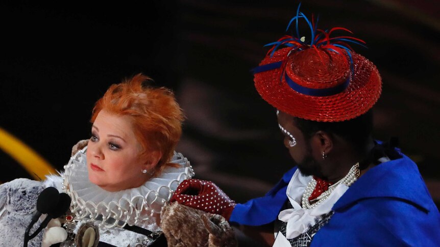 Melissa McCarthy and Brian Tyree Henry in costume on stage