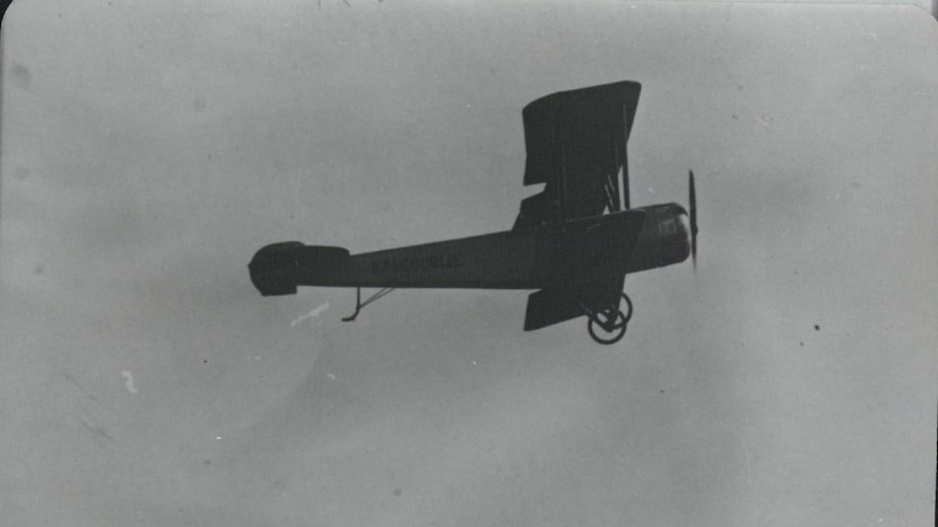 Black and white photo of the Kalgoorlie Biplane in flight.