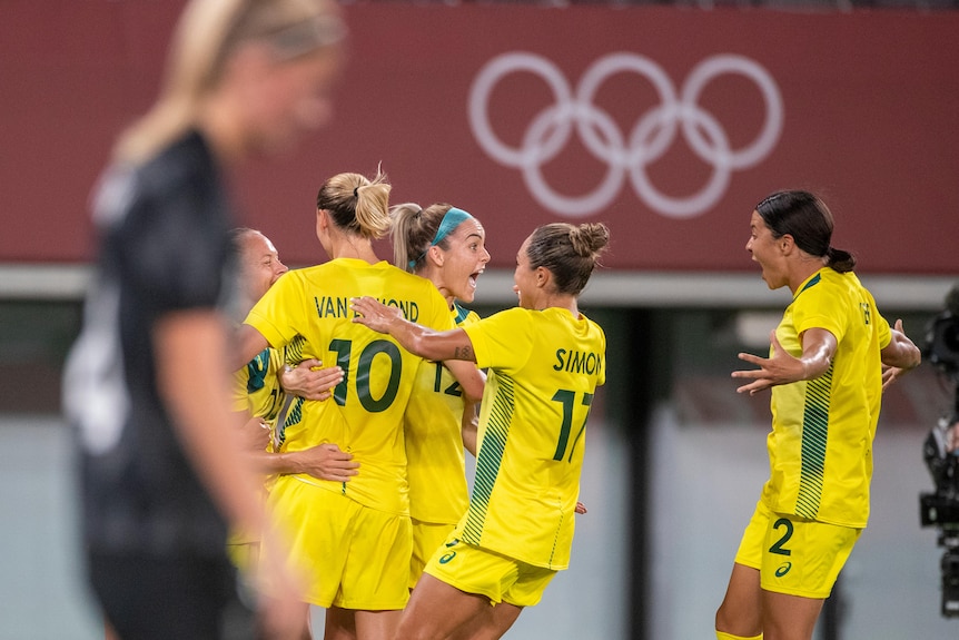 Australian Matildas Tameka Yallop, Emily van Egmond, Ellie Carpenter, Kyah Simon and Sam Kerr celebrate an Olympic goal.