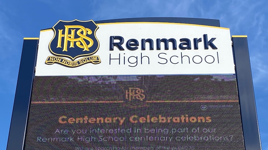 A sign that says "Renmark High School" above an LED screen with some school news.