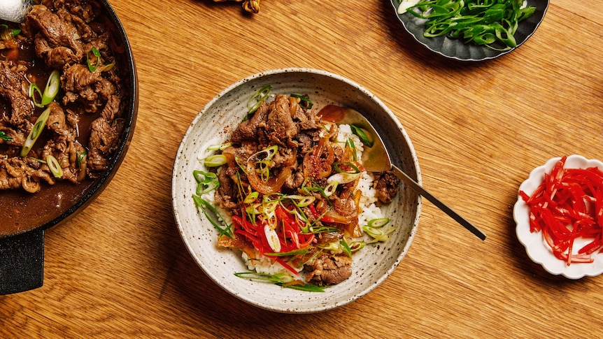 A bowl of rice topped with Gyūdon, braised beef and onions, a warming easy meal for cold nights.
