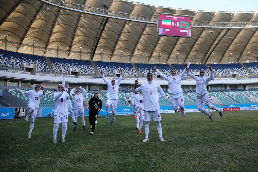 women footballers celebrate