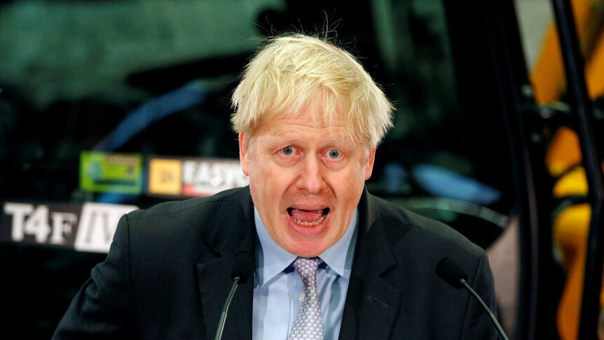 Boris Johnson behind a mic stand giving a speech