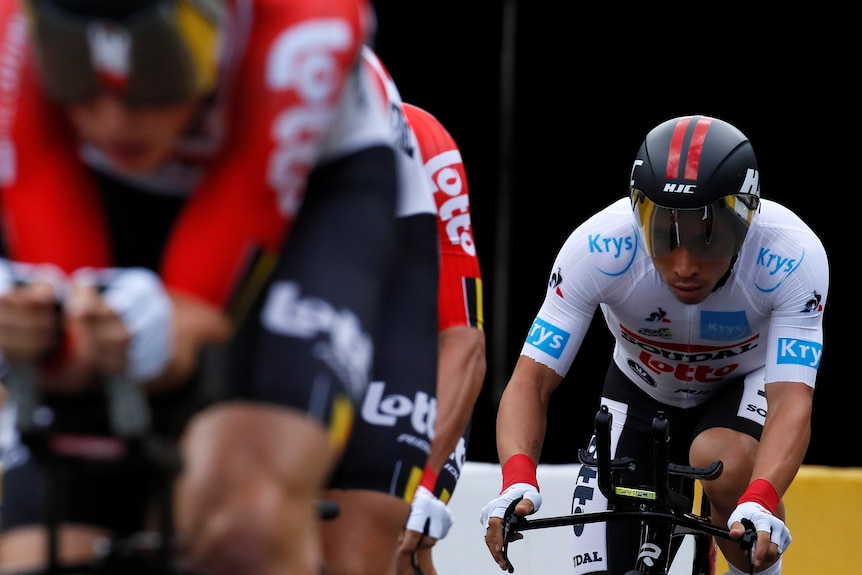 Caleb Ewan wears a white cycling kit as he tucks in behind his teammates in a team time trial at the Tour de France