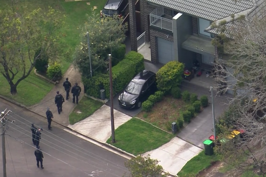 Aerial shot of police outside a house.