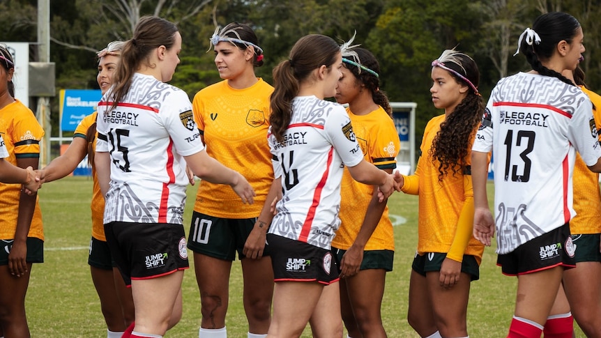 Indigenous New Zealand and Australian soccer players shaking hands after a match