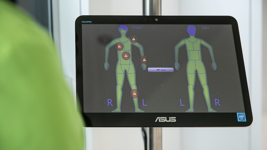 A computer screen depicts the shape of a body with red alerts in various areas.