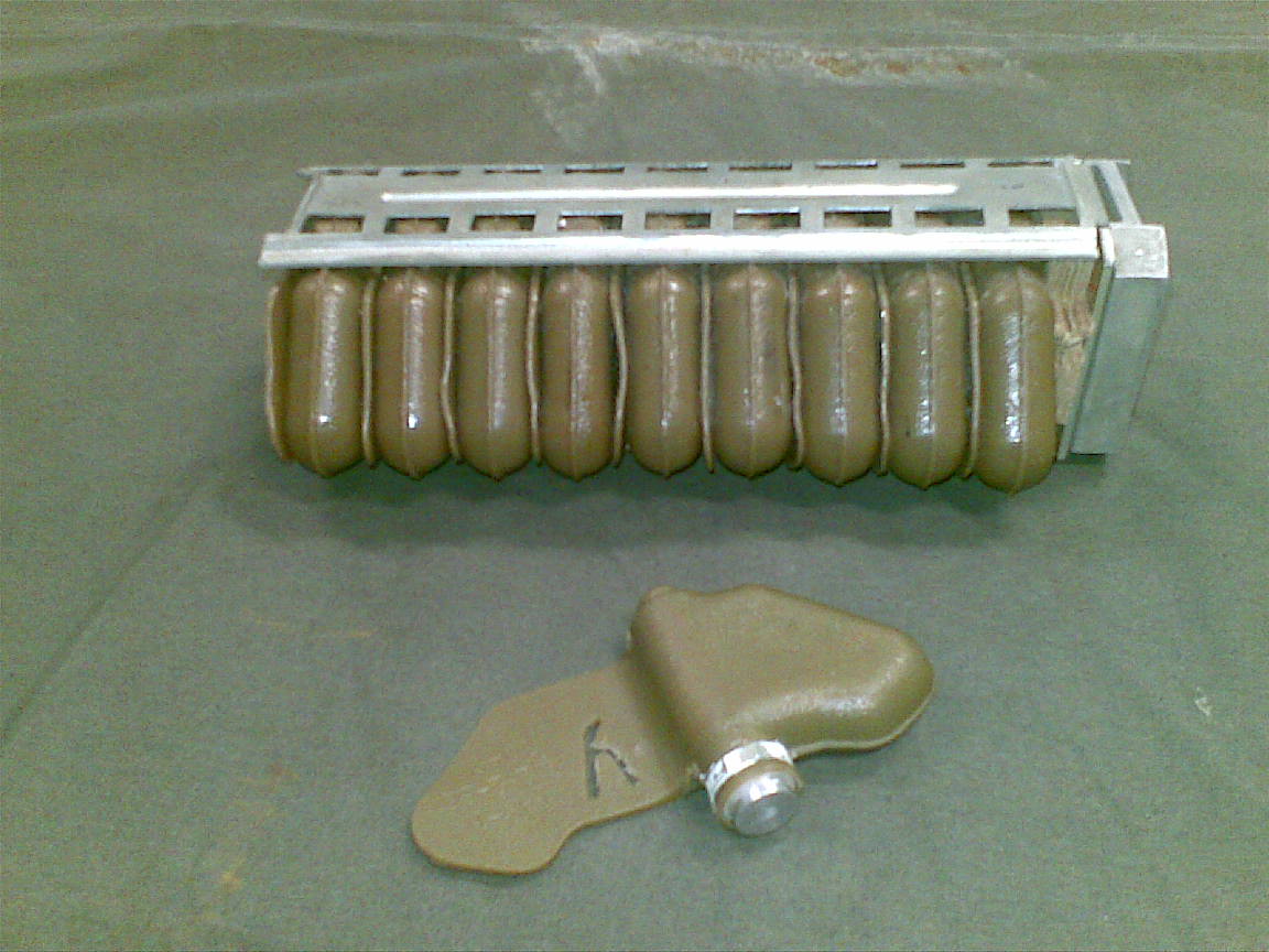 A tray of green PFM mines with one in front. 