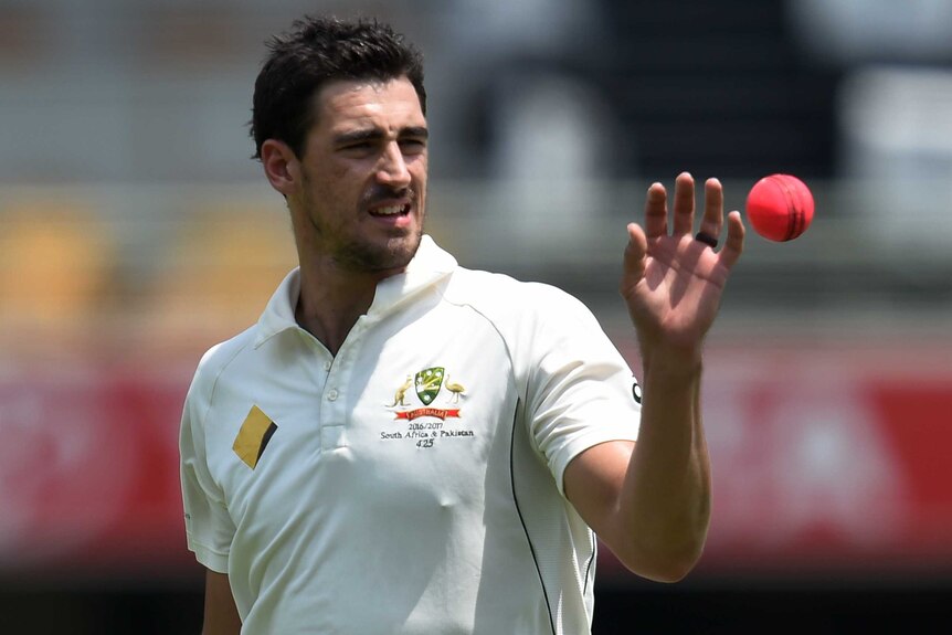 Mitchell Starc takes the ball before bowling to Pakistan