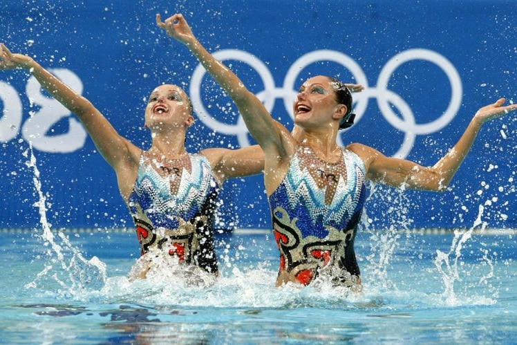 Two Russian women perform during their gold medal winning synchronised swimming duet at the Beijing Olympics.