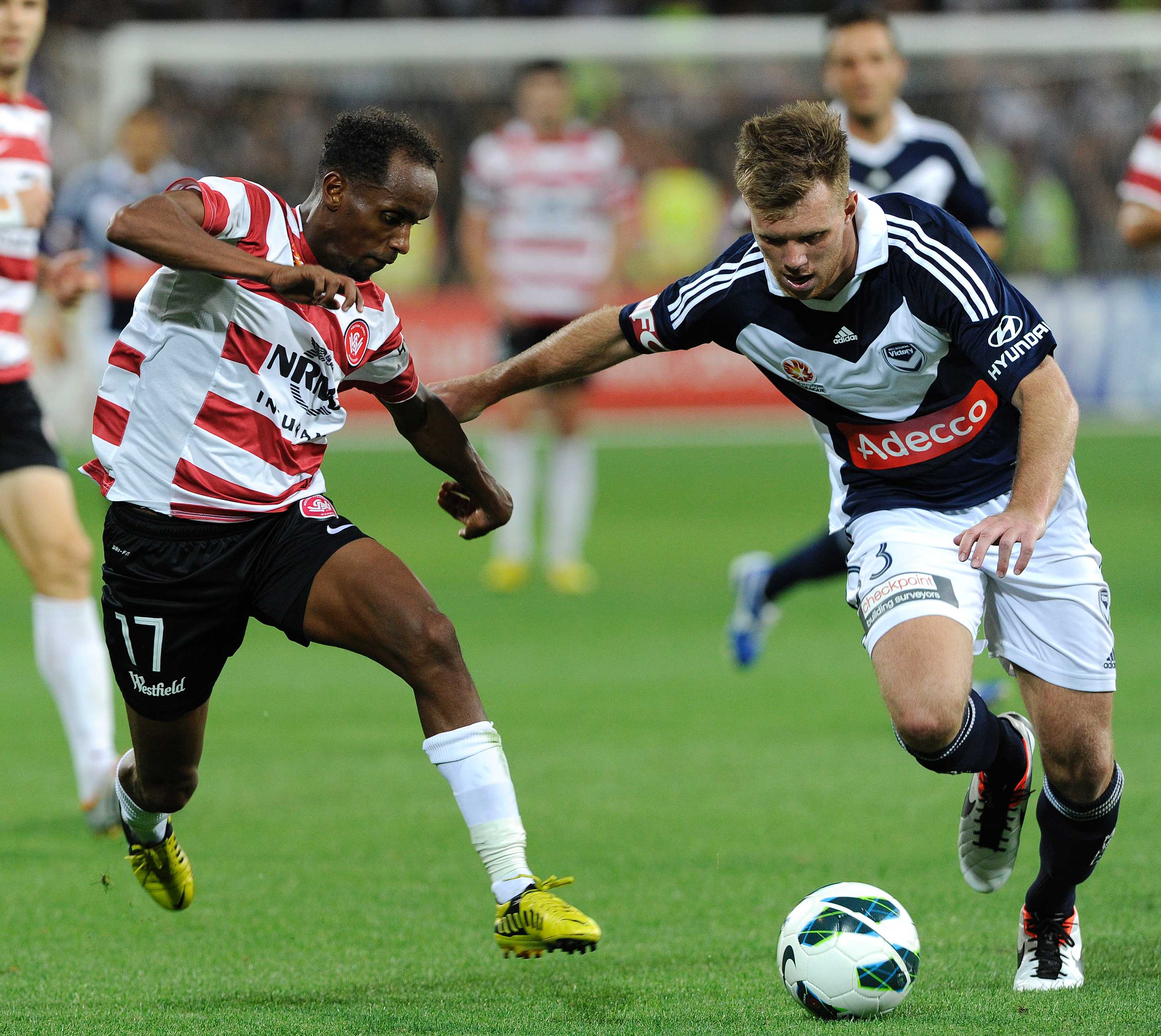 Daniel Mullen (R) takes the ball forward for Melbourne Victory