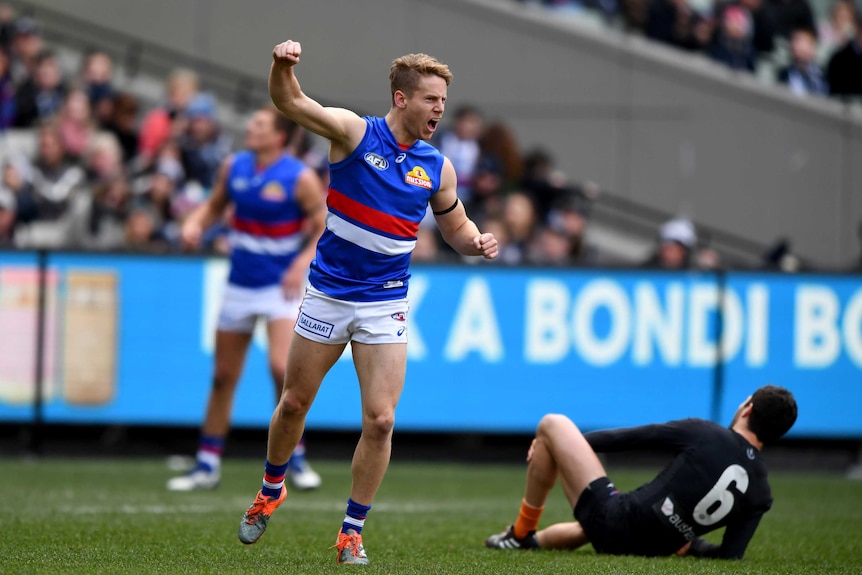 Lachie Hunter punches the air after a goal against Carlton