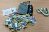 bundles of cash, grey bag and white pouch with Chinese writing
