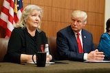 Republican presidential candidate Donald Trump looks on as Juanita Broaddrick speaks before the second presidential debate