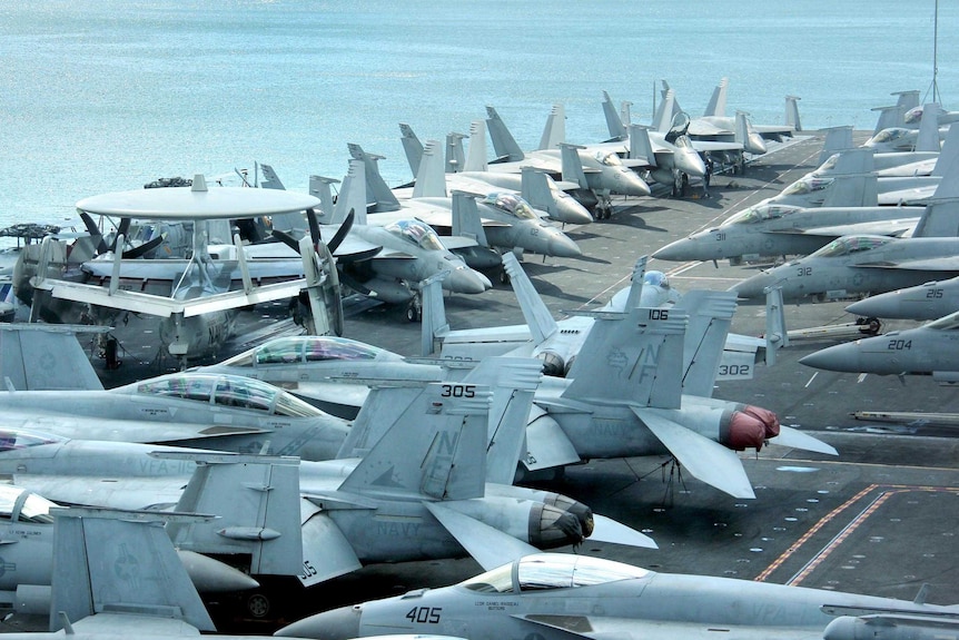 Aircraft sit on the flight deck of the USS George Washington.