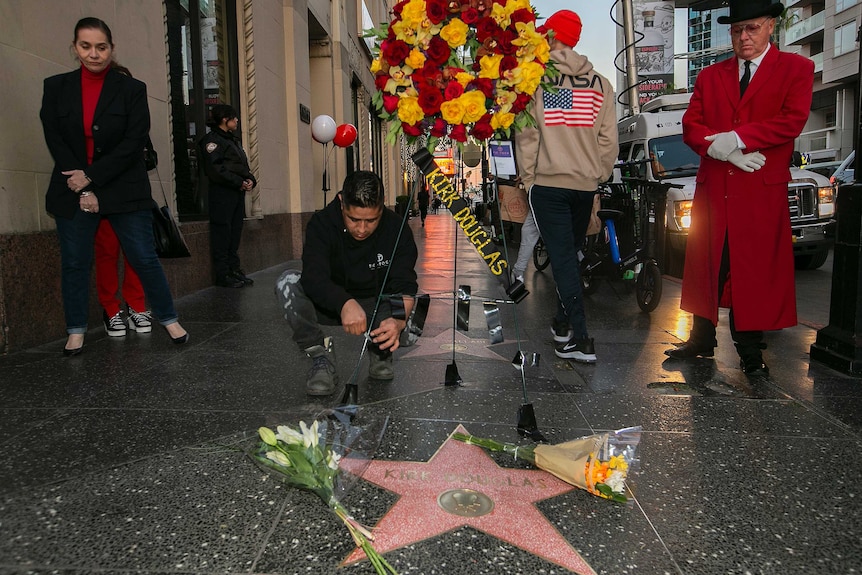 Flowers are placed on actor Kirk Douglas' star on the Hollywood Walk of Fame.