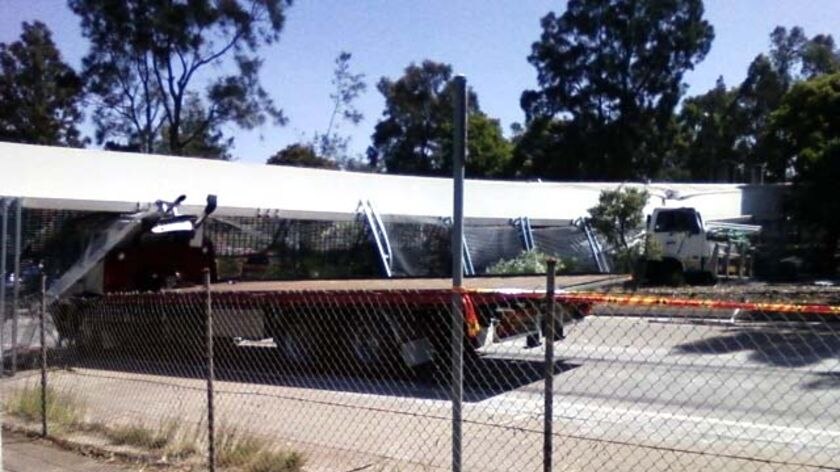 Truck wedged under a footbridge in Maitland after it collapsed over the New England Highway.