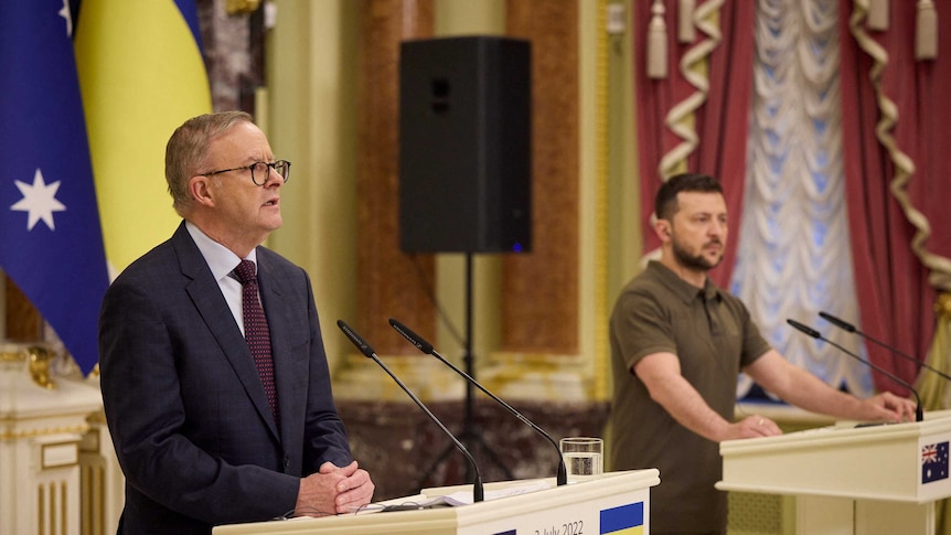 Australian Prime Minister Anthony Albanese and Ukrainian President Volodymyr Zelenskyy stand behind podiums