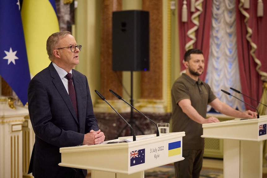 Australian Prime Minister Anthony Albanese and Ukrainian President Volodymyr Zelenskyy stand behind podiums