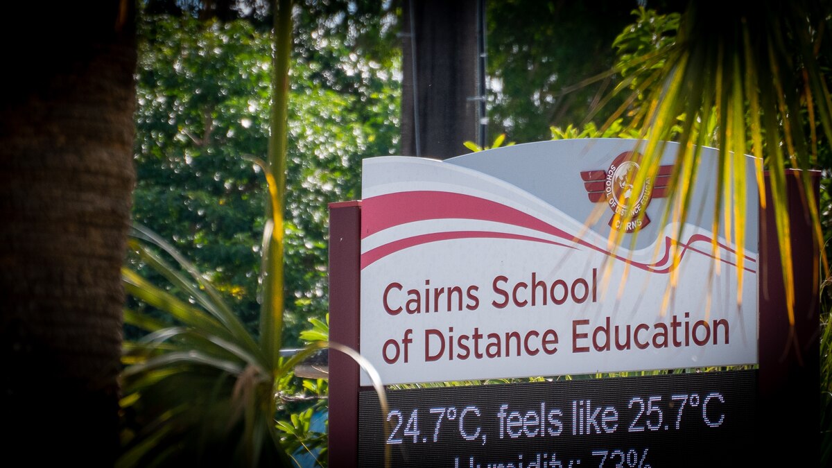 Sign at Cairns School of Distance Education surrounded by trees