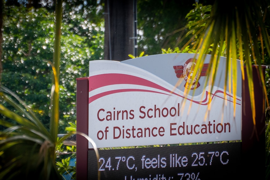 Sign at Cairns School of Distance Education surrounded by trees